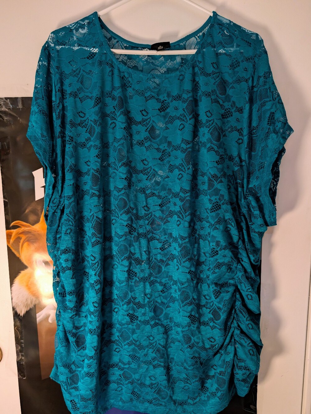 A teal green stretch lace crew neck tee from Torrid featuring ruched cinch side
